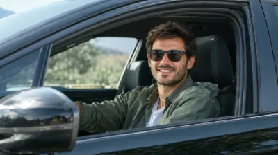 Smiling man driving a car